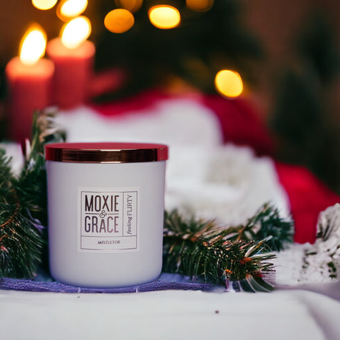 Mistletoe 12oz Candle in White by Moxie & Grace — a festive blend of pine, peppermint, eucalyptus, and fresh winter greens