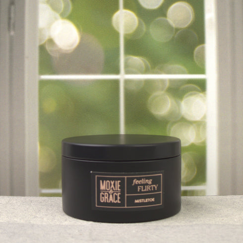 Mistletoe 5oz Candle in Black by Moxie & Grace — a festive blend of pine, peppermint, eucalyptus, and fresh winter greens