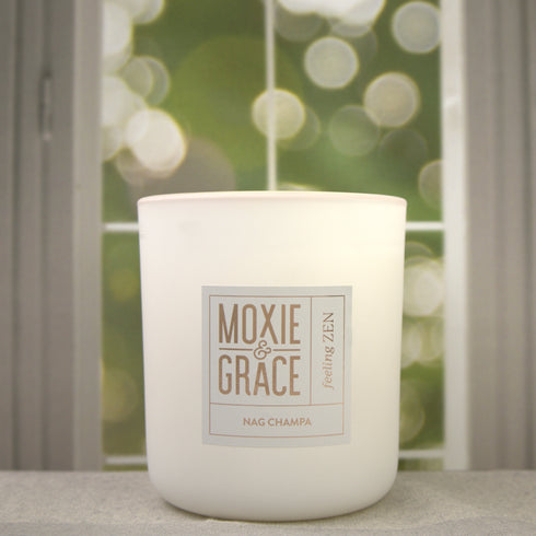 Nag Champa 12oz Candle in White by Moxie & Grace — a meditative blend of sandalwood, patchouli, amber, rose, and dark musk