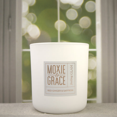 Red Ginger & Saffron 12oz Candle in White by Moxie & Grace — a vibrant blend of ginger, saffron, lemon, amber, patchouli, and cedarwood