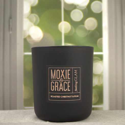 Roasted Chestnut & Rum 12oz Candle in Black by Moxie & Grace — a warm, cozy blend of roasted chestnut, dark rum, vanilla, and smoked wood