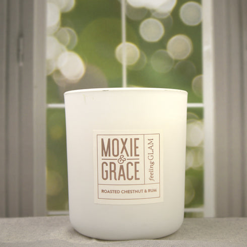Roasted Chestnut & Rum 12oz Candle in White by Moxie & Grace — a warm, cozy blend of roasted chestnut, dark rum, vanilla, and smoked wood