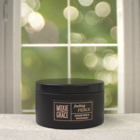 Sugar Pine & Patchouli 5oz Candle in Black by Moxie & Grace — an earthy, woodsy blend of pine, patchouli, cedar, and warm musk