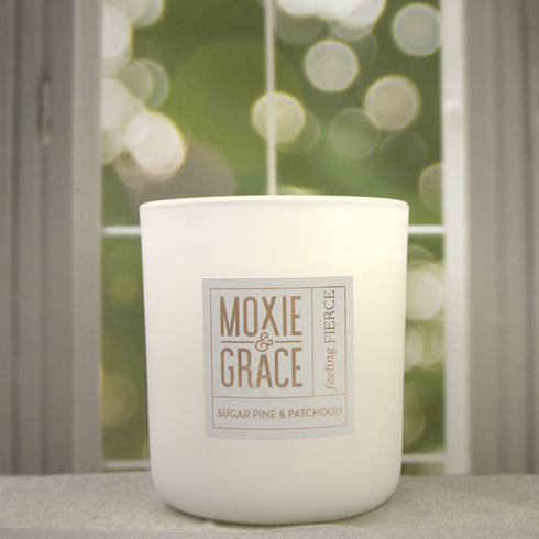 Sugar Pine & Patchouli 12oz Candle in White by Moxie & Grace — an earthy, woodsy blend of pine, patchouli, cedar, and warm musk