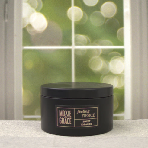 Sweet Tobacco 5oz Candle in Black by Moxie & Grace — a rich, warm blend of tobacco, vanilla, honey, amber, and dark musk