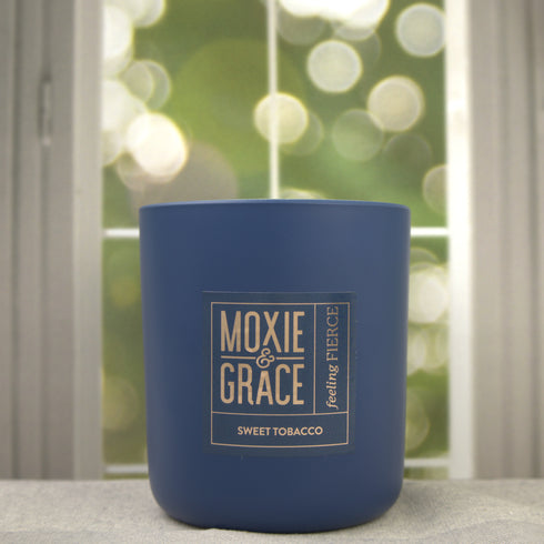 Sweet Tobacco 12oz Candle in Navy by Moxie & Grace — a rich, warm blend of tobacco, vanilla, honey, amber, and dark musk