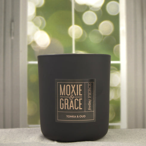 Tonka & Oud 12oz Candle in Black by Moxie & Grace — a luxurious blend of oud, tonka bean, sandalwood, amber, and dark musk