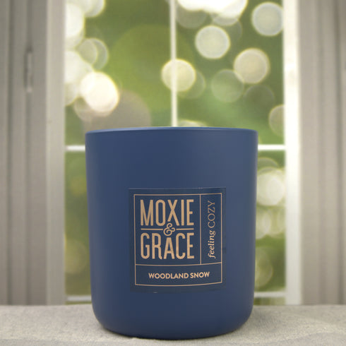 Woodland Snow 12oz Candle in Navy by Moxie & Grace — a crisp, wintry blend of pine, cedarwood, eucalyptus, and fresh snow